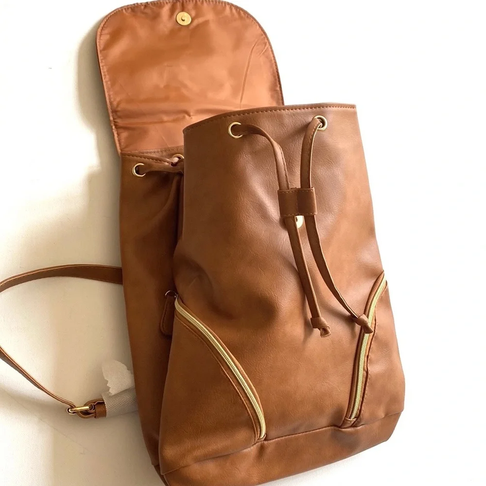 Brown backpack with zipper‎ accented detailing on front, NWOT